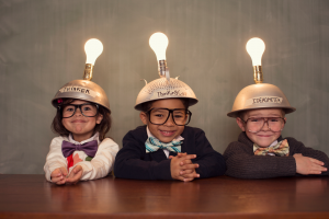 Three children with light bulb hats.